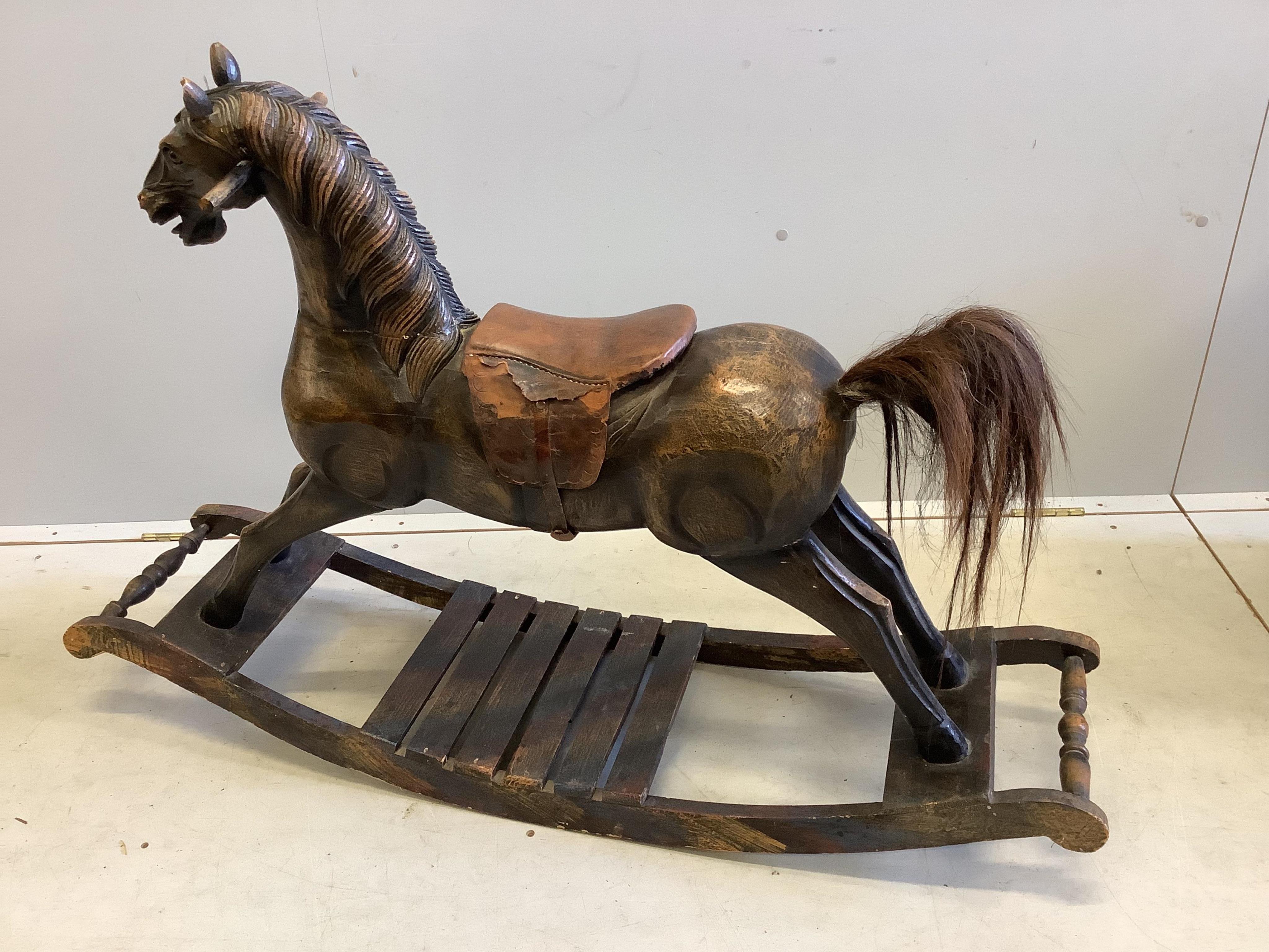 A French 19th century style child’s carved wood rocking horse, length 118cm, height 82cm. Condition - poor
